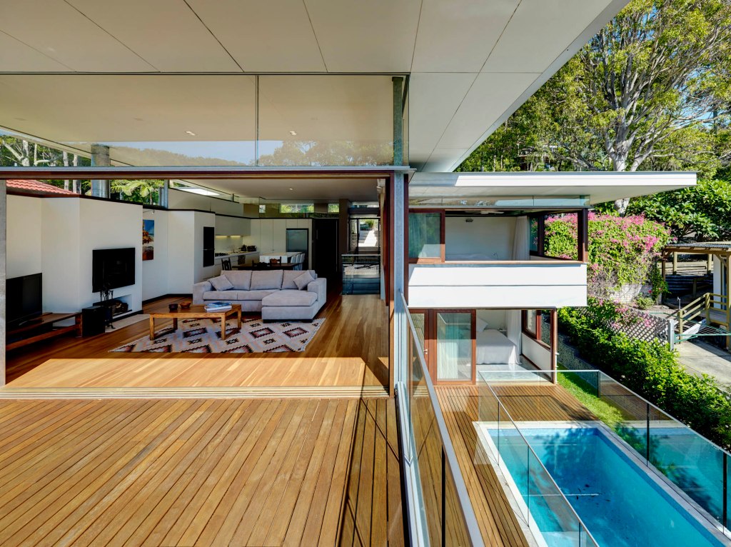 "Open-plan kitchen and lounge area flooded with natural light, Pretty Beach House."