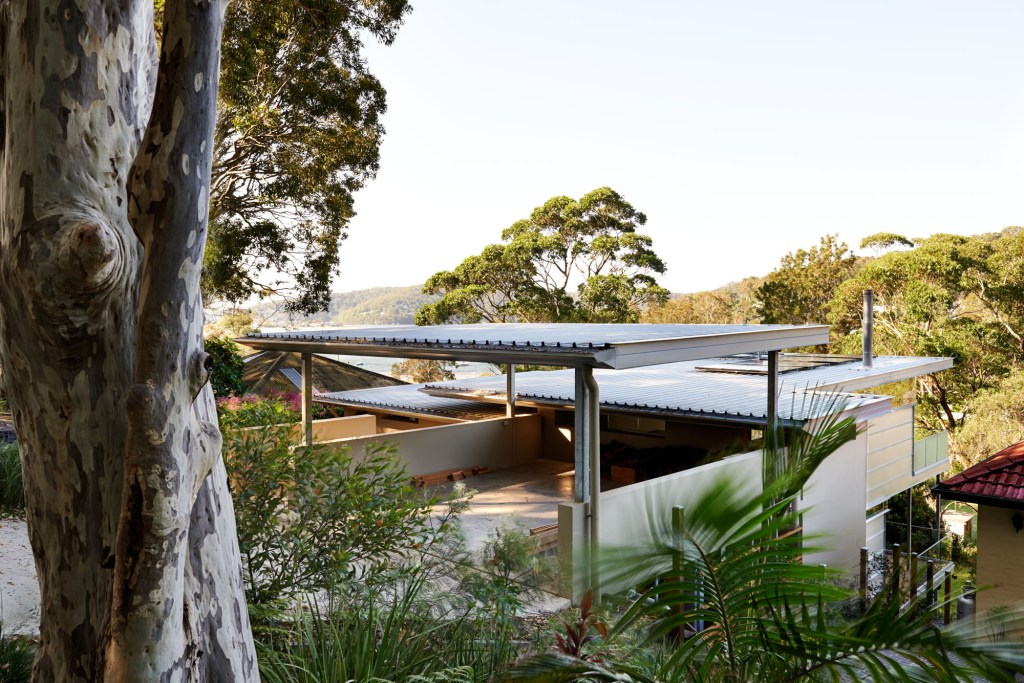 "Pretty Beach House facade – modern coastal home with timber cladding and glass by Booker Constructions."