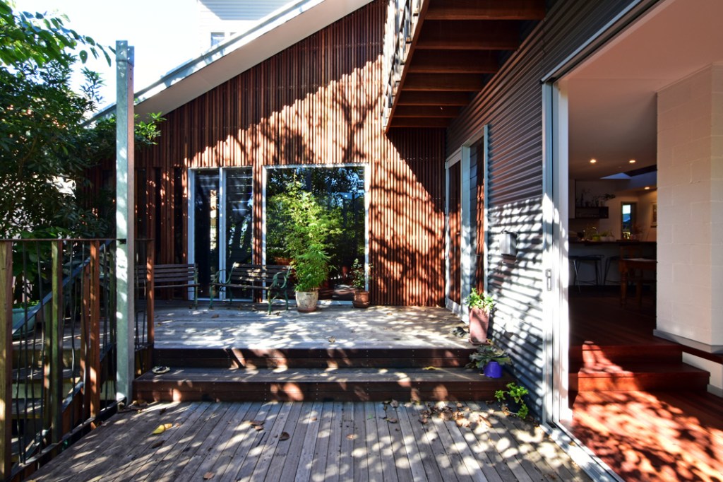"Outdoor deck with recycled hardwood cladding and privacy screen at Cooks Hill House, built by Booker Constructions."