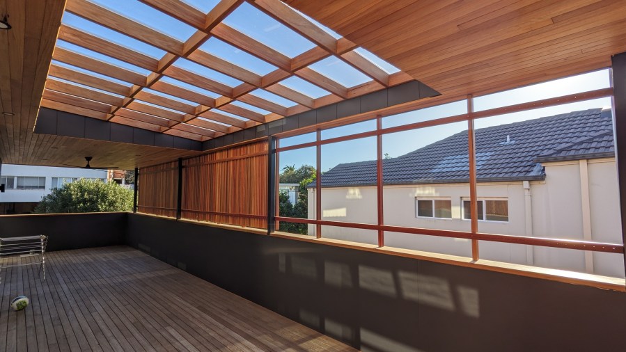 "Outdoor living area in Newcastle by Booker Constructions – custom timber deck with filtered sun and open roof design." Architect - Jodie Dixon